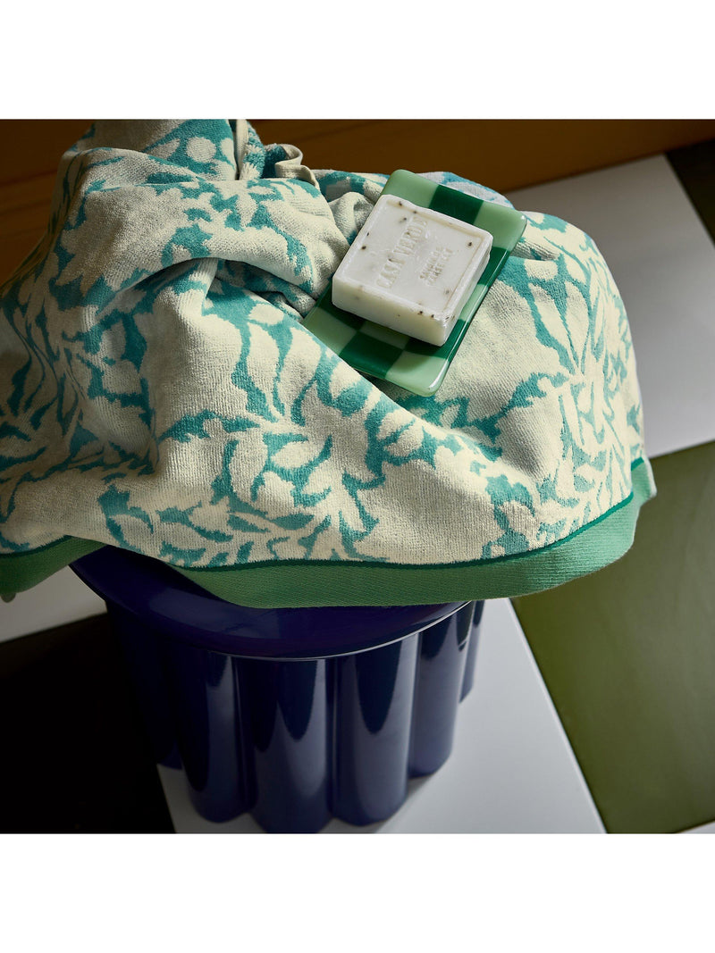 Land Shore floral blue bath towel with red and green trim, UK version