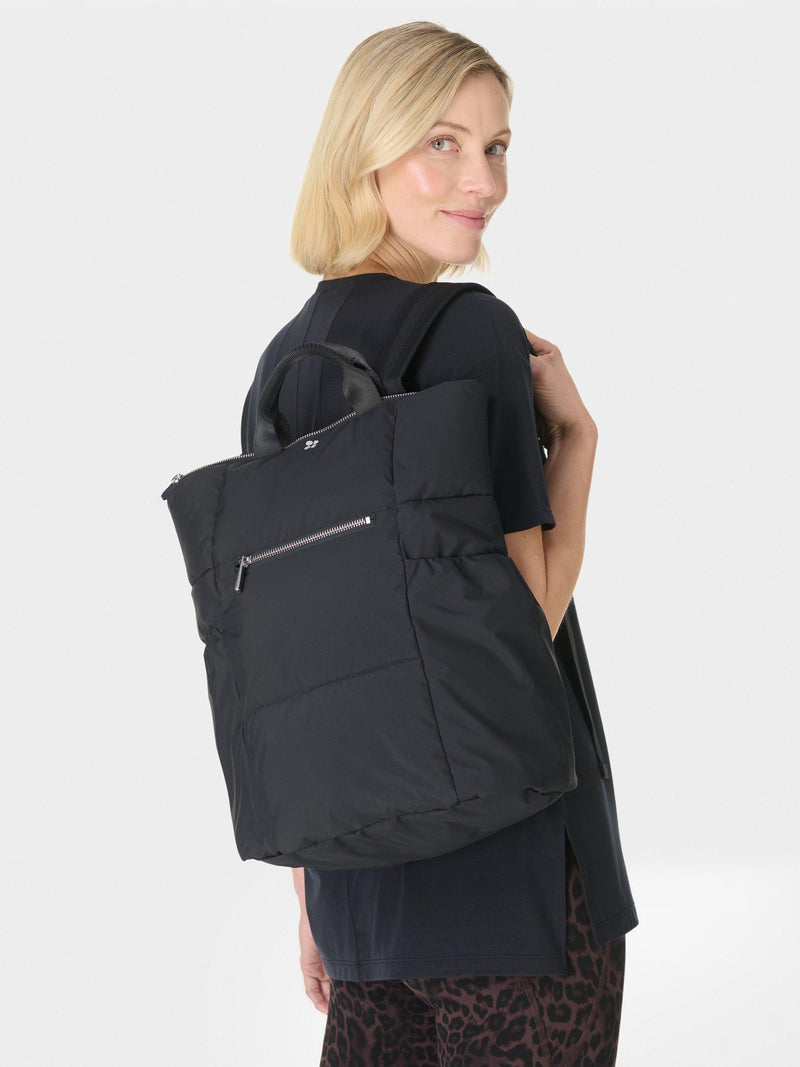 Sweaty Betty Nimbus backpack in black with reflective details, UK version