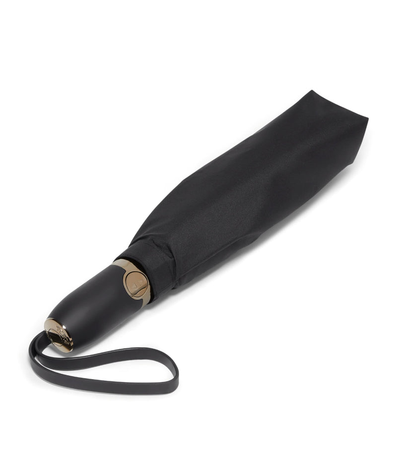 Tumi medium umbrella with red accents and reflective trim (British brand)