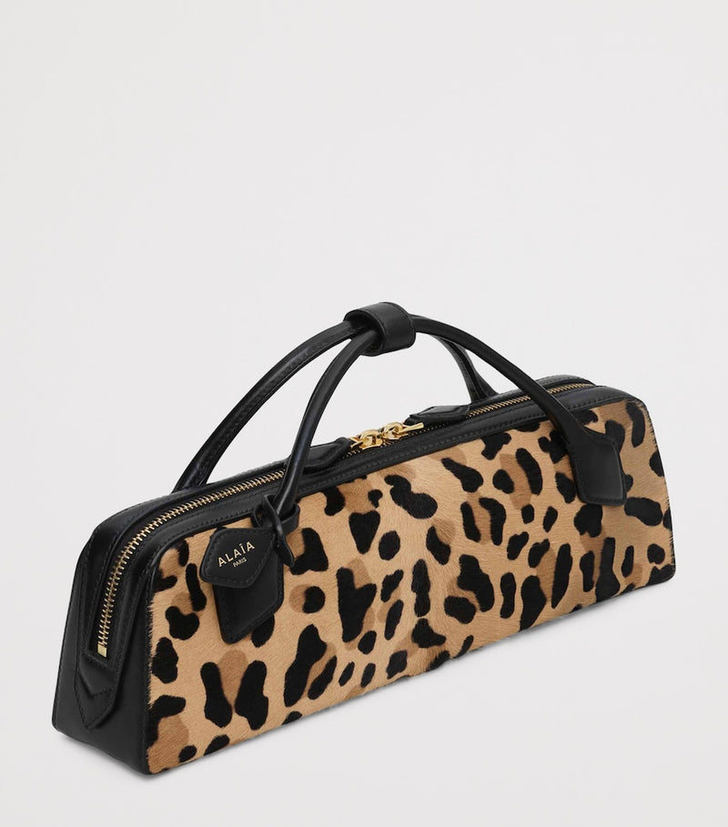 Alaïa Le Teckel leopard print clutch bag, imported from the UK