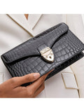 Aspinal of London patent croc clutch bag in black, imported from the UK
