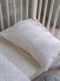 Avery Row cotbed fitted sheet nettle scatter pattern imported from the UK