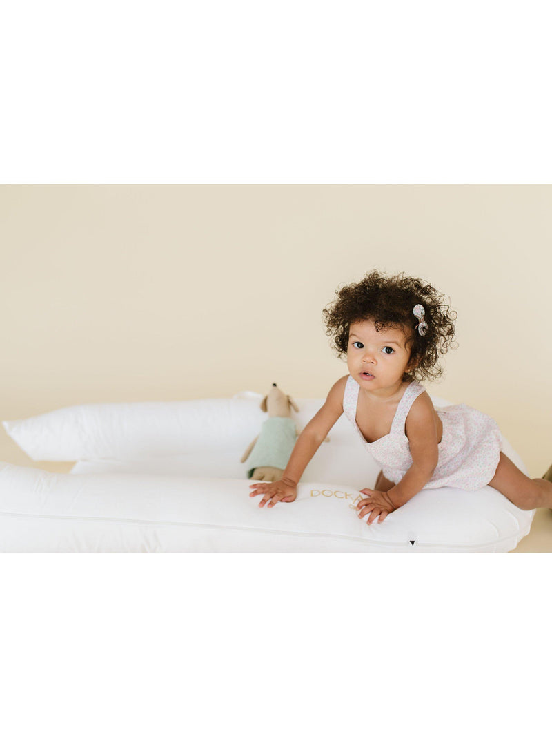 DockATot Grand Toddler Dock white toddler lounger, imported from the UK