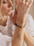 Daisy London crystal bead bracelet black cord gold, UK version