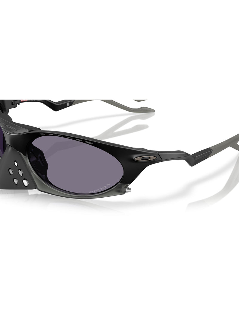 Oakley OO9437 tinted oval sunglasses, imported from the UK