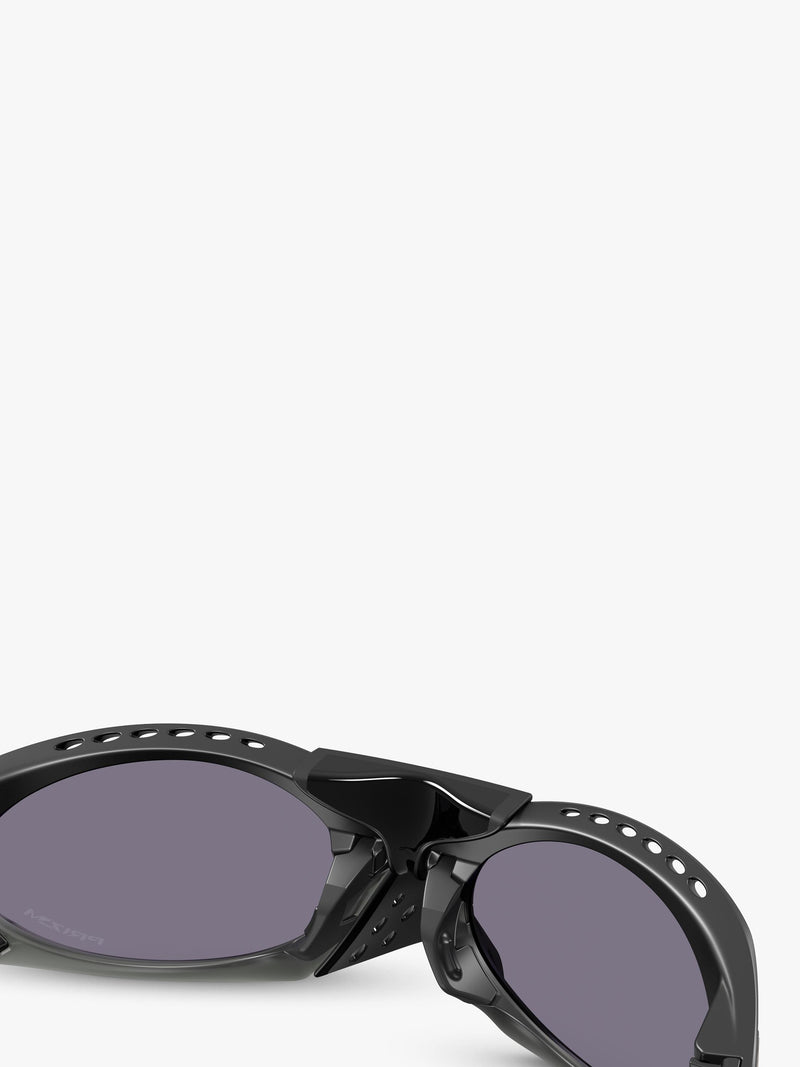 Oakley OO9437 tinted oval sunglasses, imported from the UK