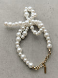 Completedworks glass pearl bow bracelet gold, UK version