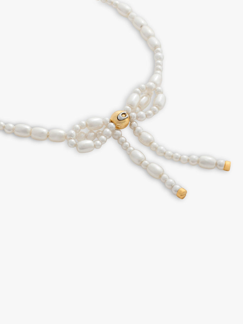Coach pearl bow bracelet with gold tone accents, UK version