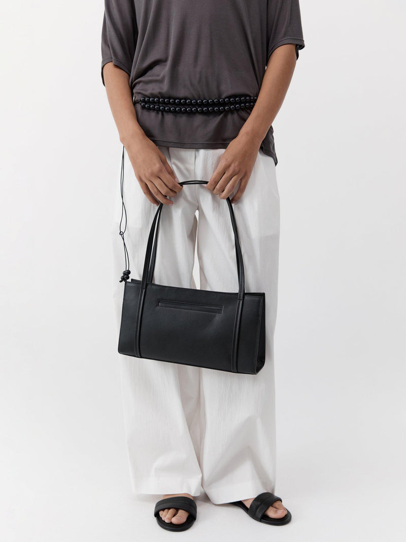 St. Agni minimal black leather pocket bag, UK version
