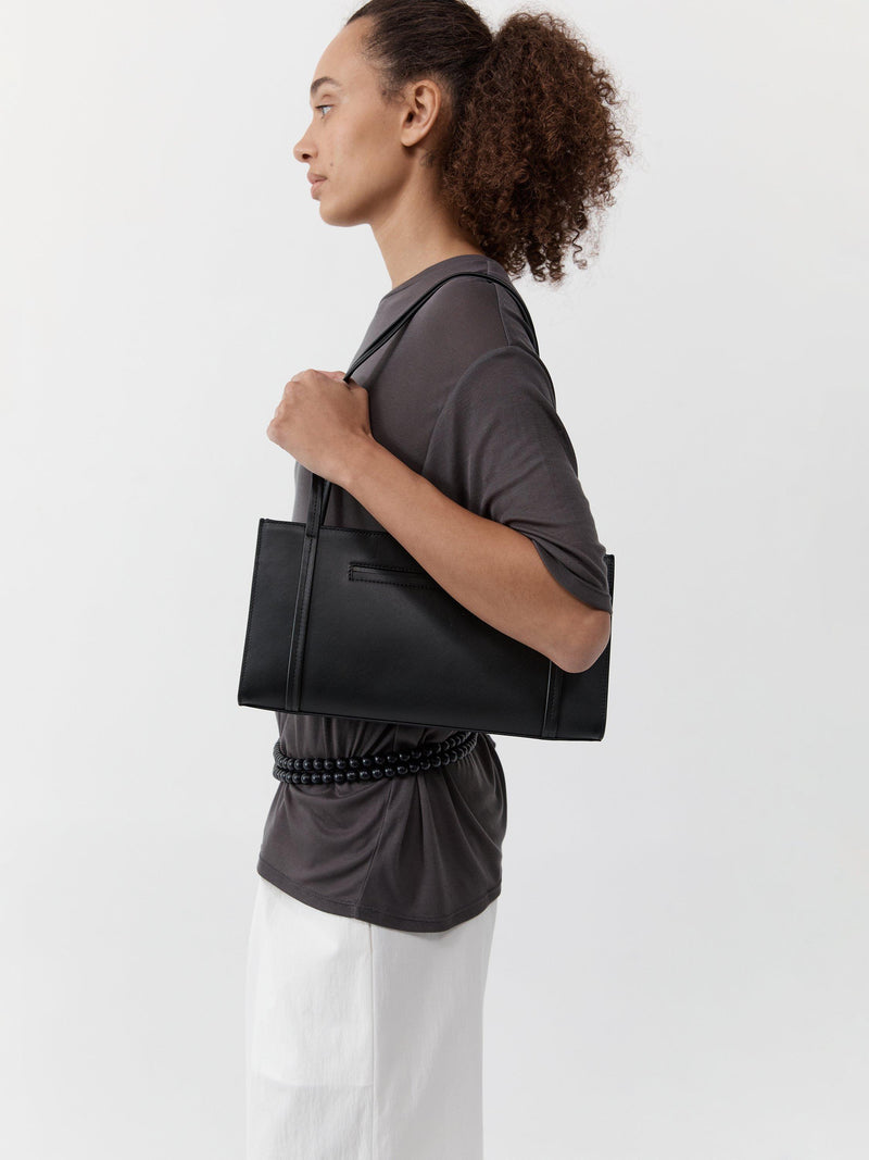 St. Agni minimal black leather pocket bag, UK version