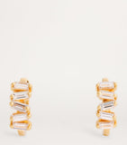 Suzanne Kalan yellow gold huggie earrings with baguette diamonds (British brand)