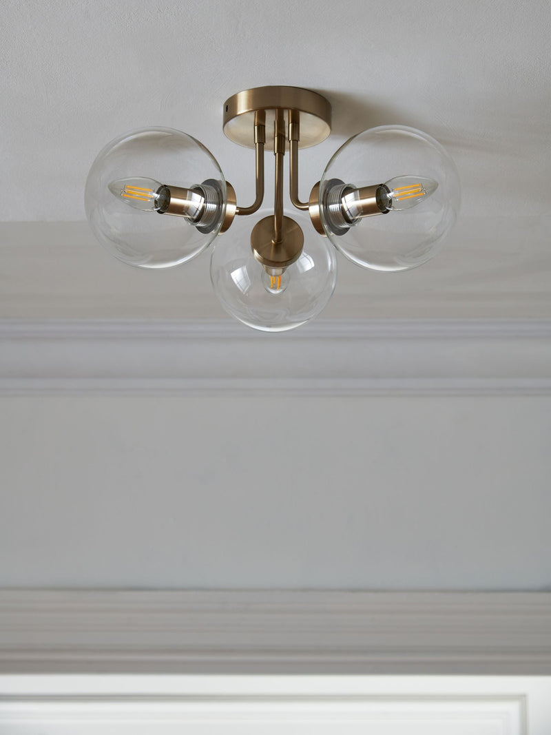 Brass Jackson flush ceiling light with three clear glass shades, UK version