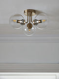 Brass Jackson flush ceiling light with three clear glass shades, UK version
