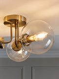 Brass Jackson flush ceiling light with three clear glass shades, UK version