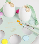 Kit de manualidades para pintar huevos de madera de Pascua con pinturas y pinceles.