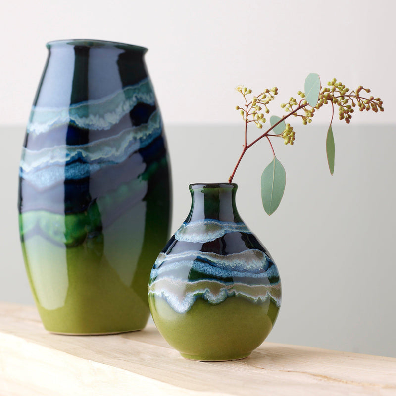 Poole Pottery green hourglass-shaped bud vase with 12cm height, imported from the UK