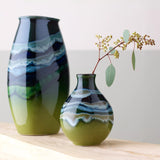 Poole Pottery green hourglass-shaped bud vase with 12cm height, imported from the UK