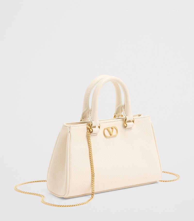Valentino Garavani VLogo Mini top-handle bag in grained leather (British brand)
