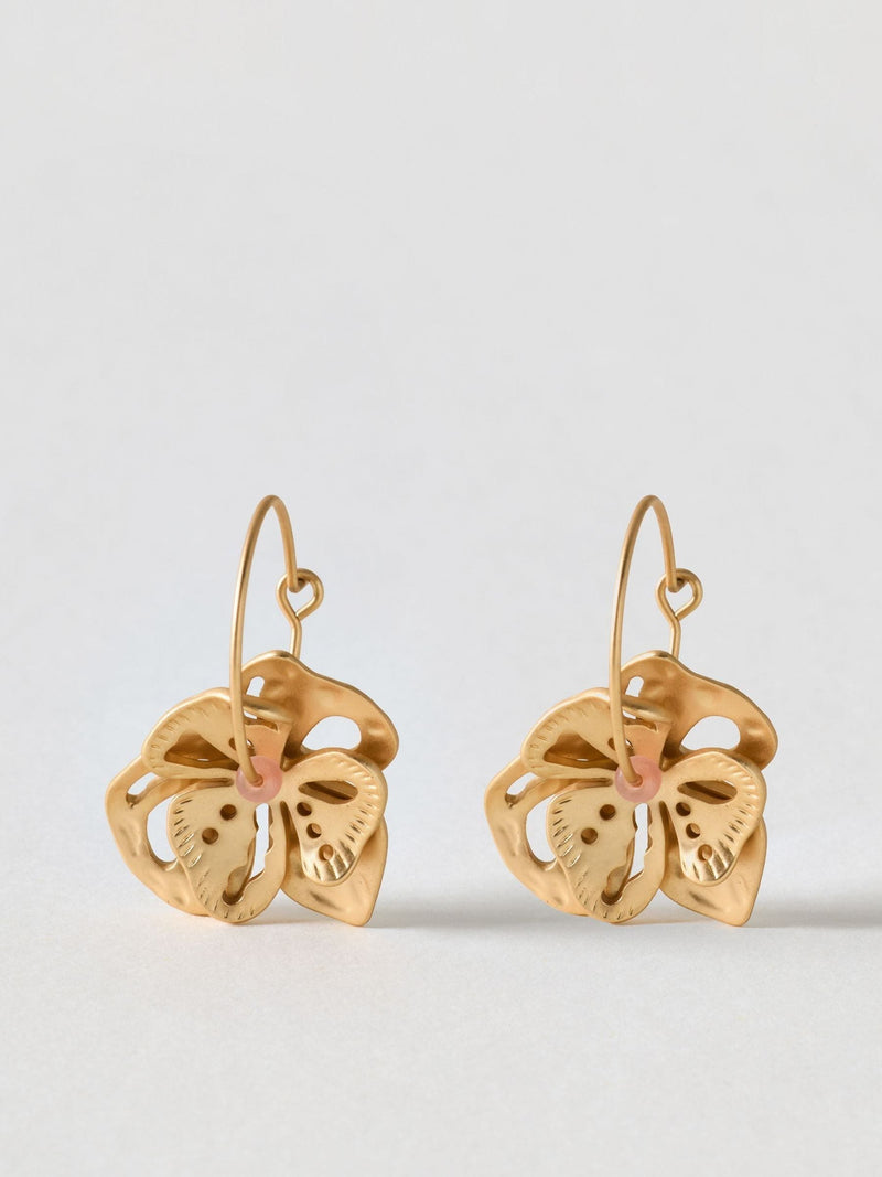 Oliver Bonas gold tone hoop earrings with flower charm, UK version