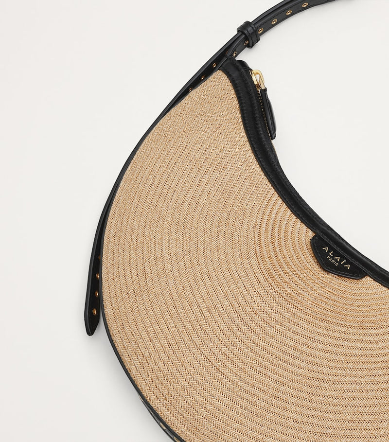 Alaïa Demi Lune woven straw shoulder bag - British product