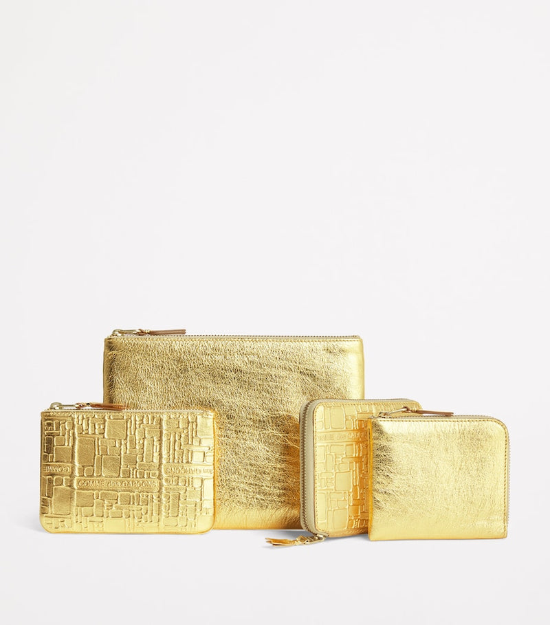 Comme Des Garçons gold embossed leather wallet, imported from the UK