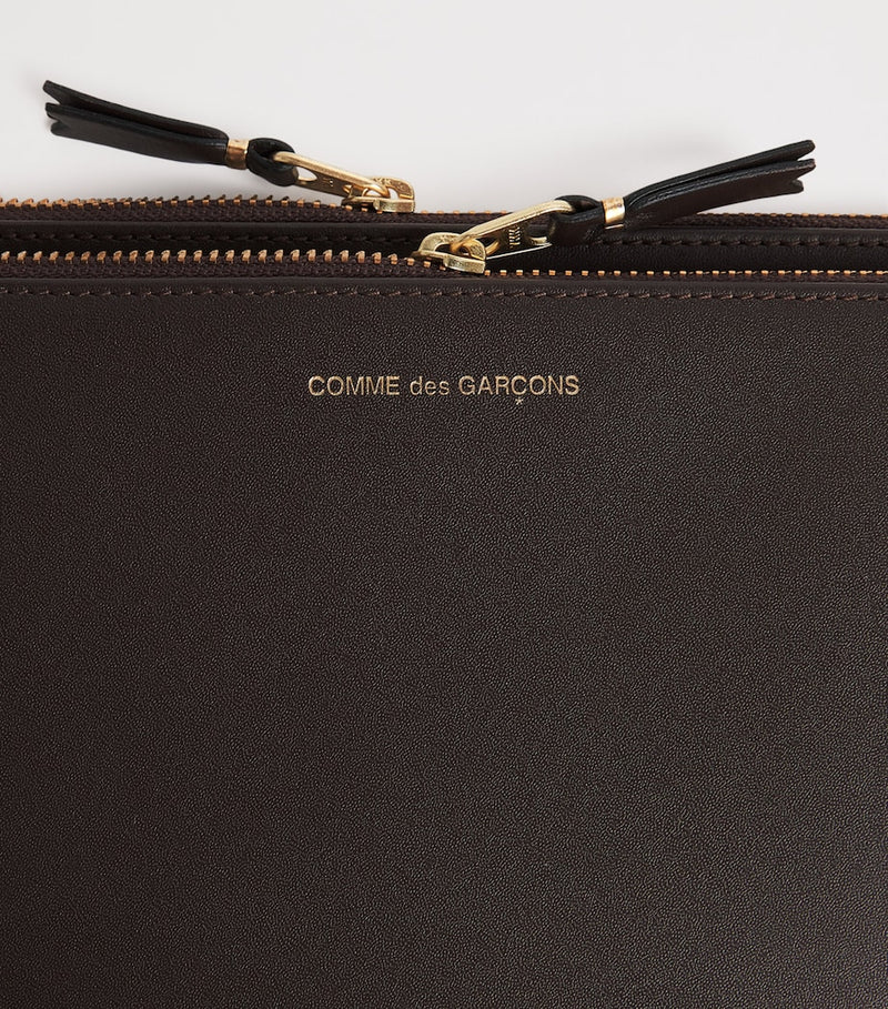Comme Des Garçons large leather exterior pocket wallet, imported from the UK