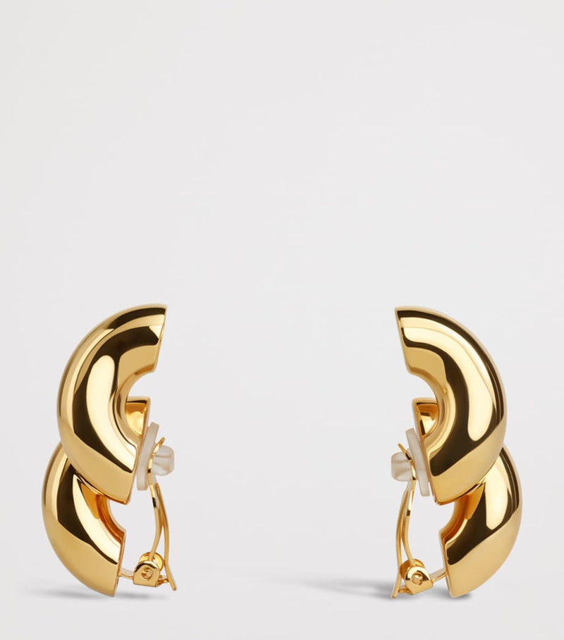 Alaïa Torsion drop earrings brass, imported from the UK