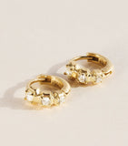 Jade Trau mini yellow gold diamond huggie earrings, imported from the UK