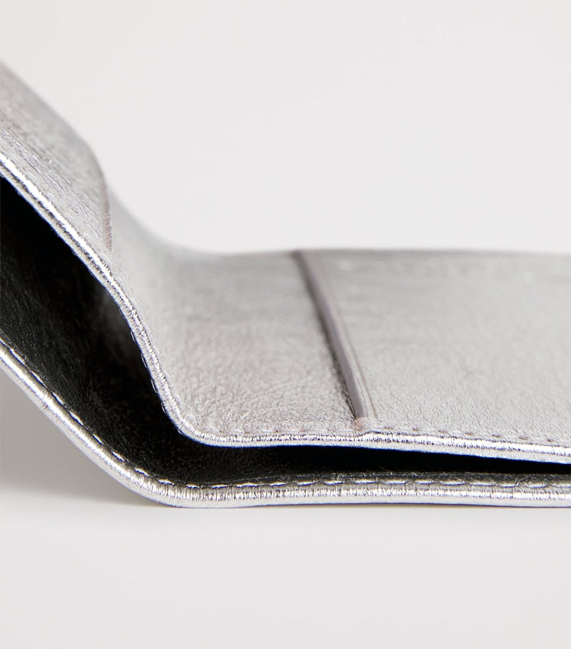 Comme des Garçons vertical bifold card holder with gold accents, imported from the UK
