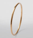 Annoushka yellow gold bangle with hand-hammered finish, imported from the UK