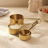 Habitat set of 4 brass-coloured steel measuring cups, imported from the UK
