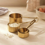 Habitat set of 4 brass-coloured steel measuring cups, imported from the UK