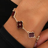 Lipsy gold clover bracelet with burgundy charm, UK version