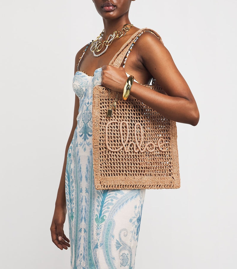 Chloé handwoven banana tote bag with gold charm, imported from the UK