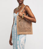 Chloé handwoven banana tote bag with gold charm, imported from the UK