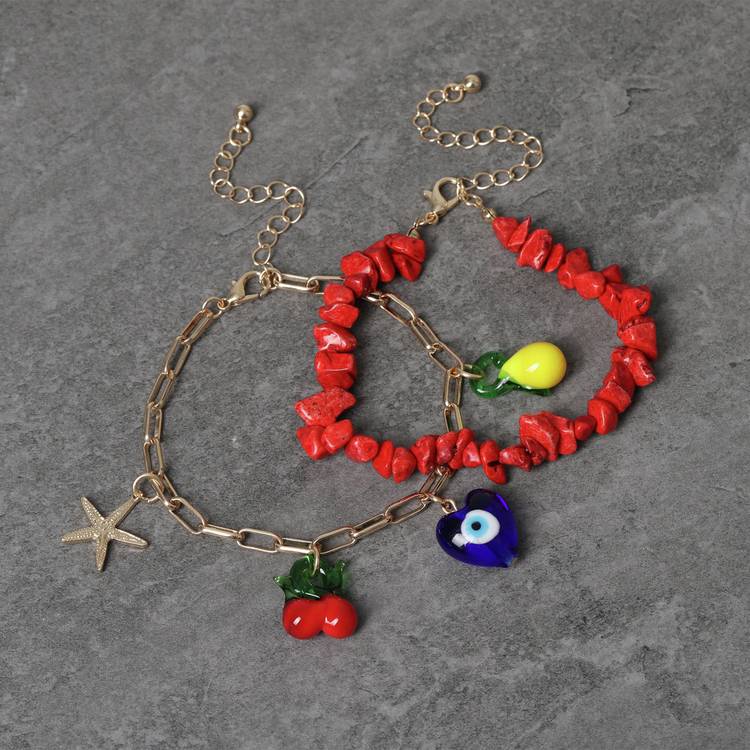 Freedom charm bracelet gold tone with red bead detail 19cm, imported from the UK
