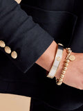 Lauren Ralph Lauren gold tone crest bangle, UK version