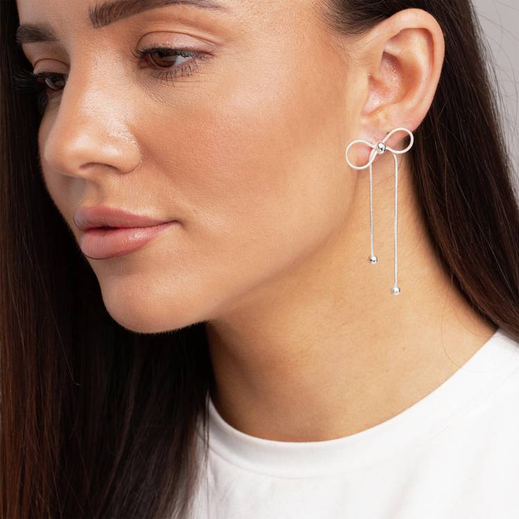 Freedom silver-tone bow drop earrings (British brand)
