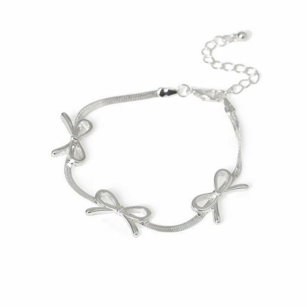 Freedom silver-tone three bows thin bracelet 19cm, imported from the UK