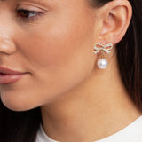 Freedom gold tone crystal bow pearl drop earrings, imported from the UK