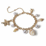 Freedom gold tone pearl shell charm bracelet, UK version