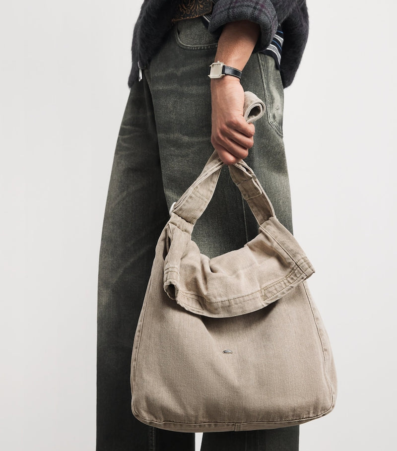 Our Legacy denim sling shoulder bag with mineral pigment, imported from the UK