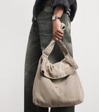Our Legacy denim sling shoulder bag with mineral pigment, imported from the UK