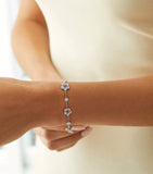 Boodles 18kt white gold diamond blossom charm bracelet, imported from the UK