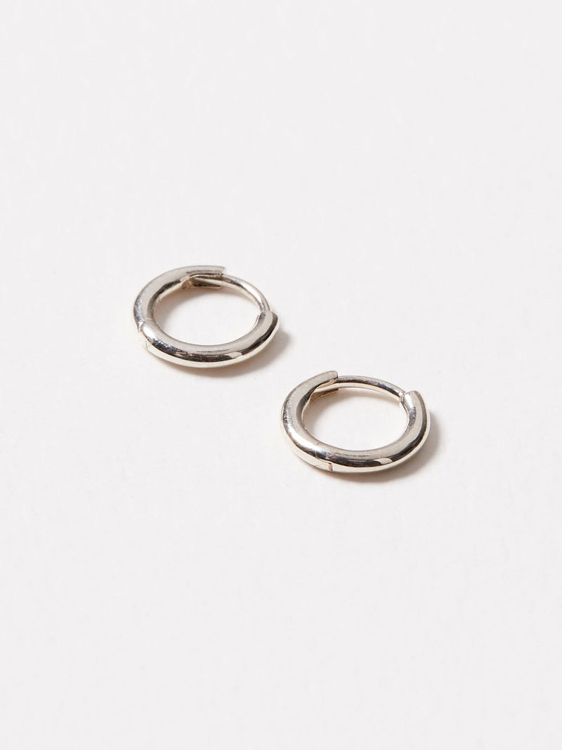 Oliver Bonas silver tone juniper mini huggie earrings, imported from the UK