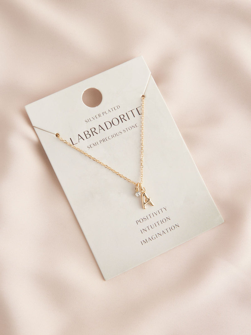 Gold tone initial necklace with letter pendant, UK version