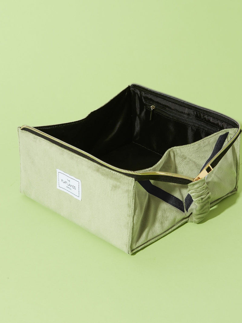 Flat Lay Co. sage green velvet makeup bag (British brand)