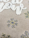 Paoletti green Christmas cushion with Let It Snow embroidery - British product