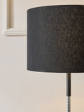 Sosandar black floor lamp with amber glass base, imported from the UK