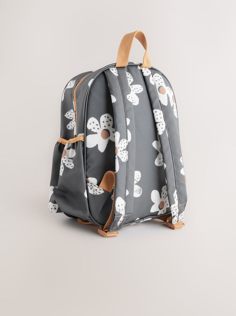 Black floral backpack with daisy design and adjustable straps, UK version